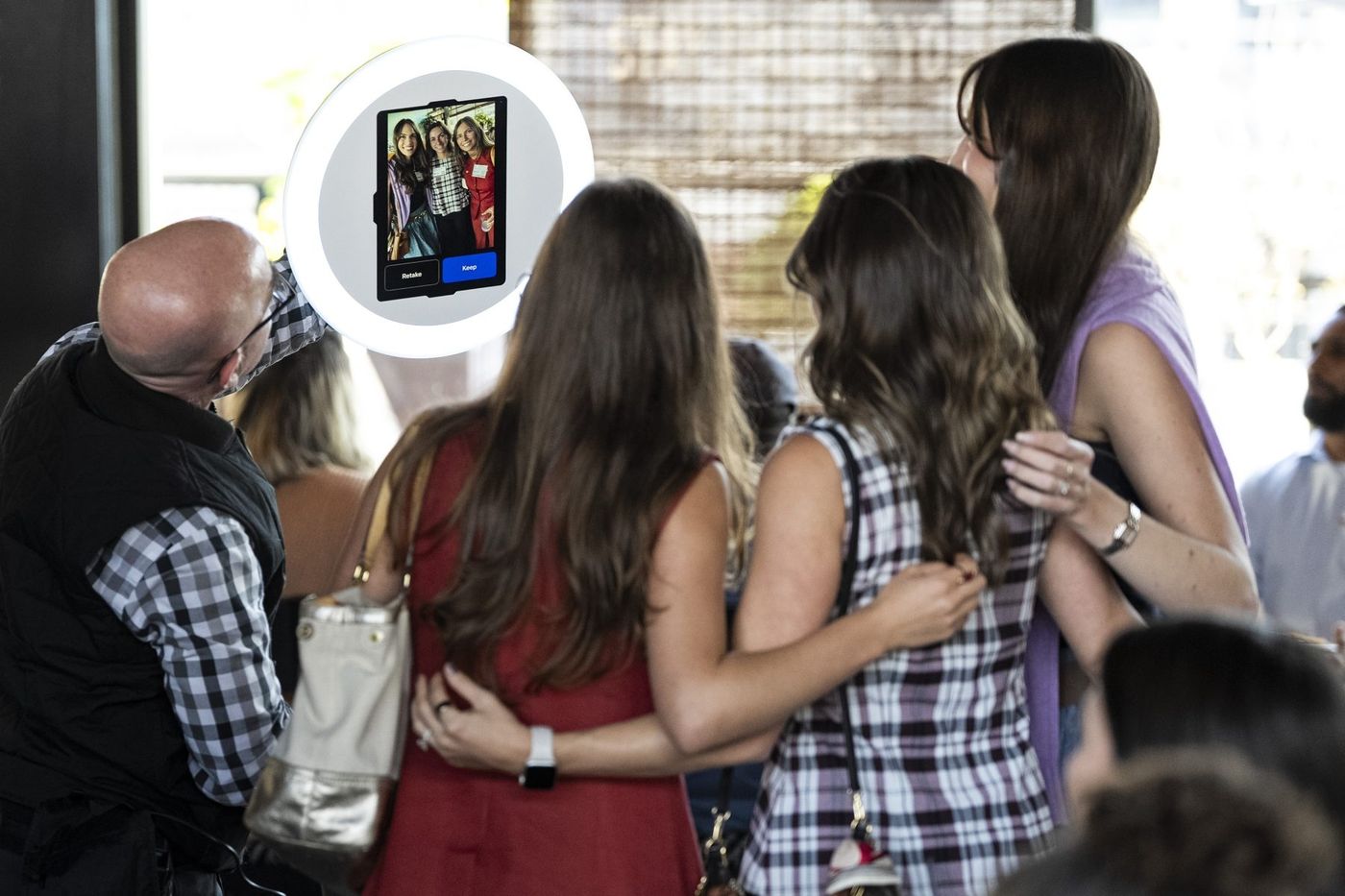 Guests watching their Setpiece photo appear on an iPad in a ring light